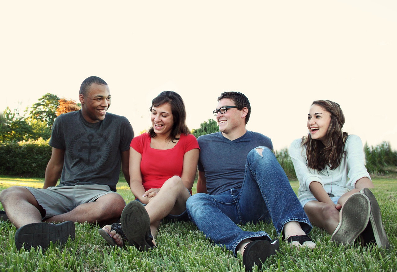 friends sitting on the grass